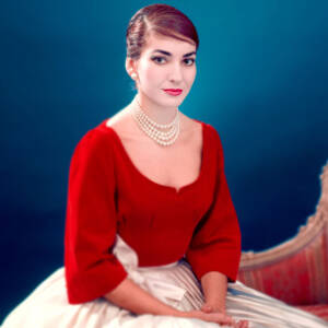 Zdjęcie kobiety w czerwono-białej sukni z białymi perłami na szyi